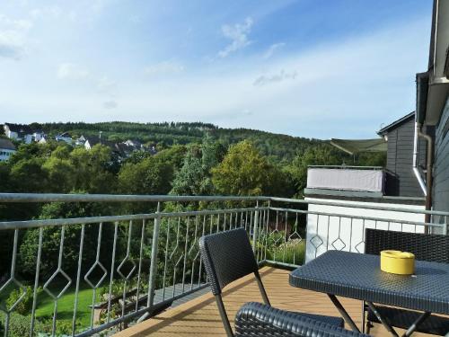 eine Terrasse mit einem Tisch und Stühlen auf dem Balkon in der Unterkunft Ferienwohnung Klose in Schmallenberg