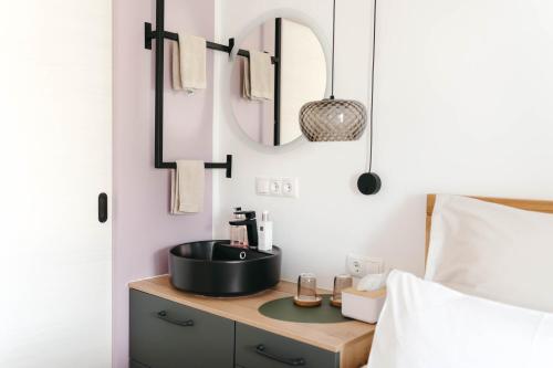 a bathroom with a sink on a counter next to a bed at Pension Blumenwiese in Burgau