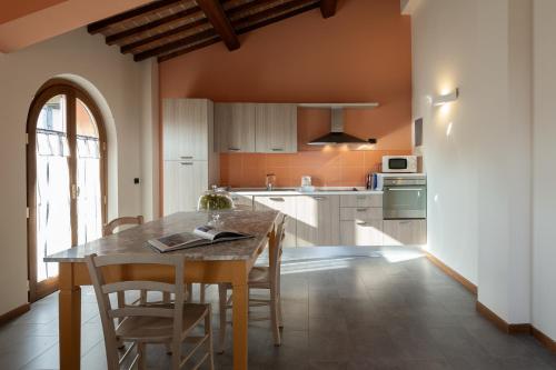 a kitchen with a table and chairs in a room at Incanto Toscano in Larciano