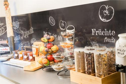 a counter with many different types of food at Hotel Newton Ludwigshafen in Ludwigshafen am Rhein