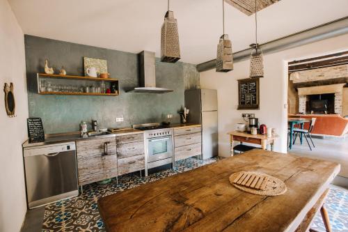 a kitchen with a wooden table and a wooden counter top at Ecolodge La Belle Verte in Saint-Mʼhervé