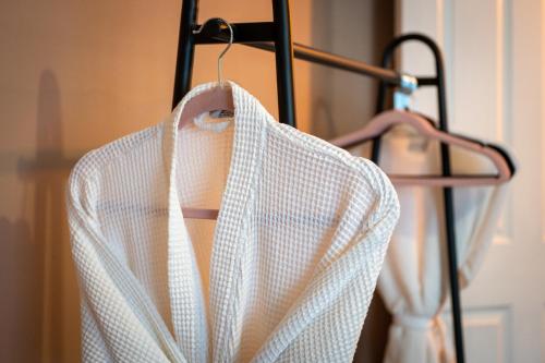 a white shirt hanging on a rack at At Home Apartments in Shrewsbury