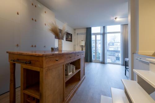 a large kitchen with a wooden island in a room at Keizersgracht Eindhoven in Eindhoven