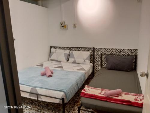 a bedroom with two beds and a mirror at Fastbook Ferringhi SoHo unit 8pax in Batu Ferringhi