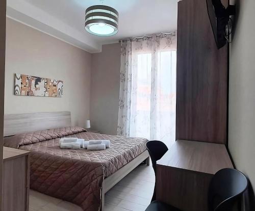 Un pat sau paturi într-o cameră la Giliberto Rooms