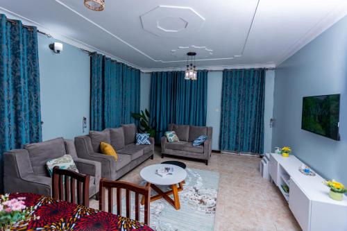 a living room with a couch and a table at The Mbuya Residence in Kampala