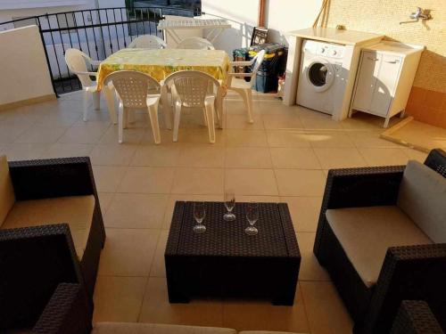 a living room with a table and chairs and a washing machine at Residence Boccaccio in Torre Pali 