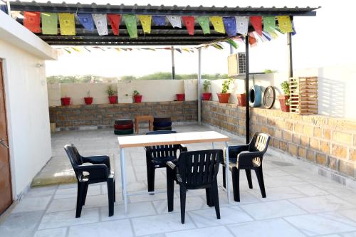 a patio with a table and chairs on a patio at The Travel Bug Jaisalmer in Jaisalmer