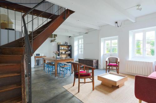 - un salon avec un escalier, une table et des chaises dans l'établissement Ker Ar Vro - Maison atypique, à Locquirec