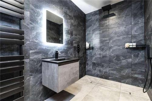 a bathroom with a sink and a shower at old school house in Skipton