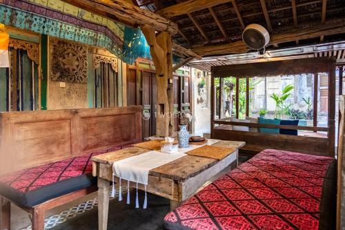 a train car with a table and chairs in a room at Kayu Beach Villa by TwoSpaces, Nusa Dua Beach in Nusa Dua
