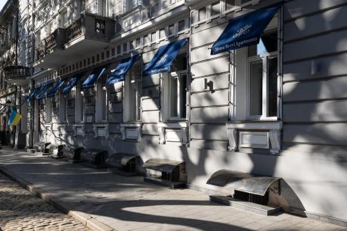 a row of blue flags on the side of a building at Metro Hotel Apartments in Odesa