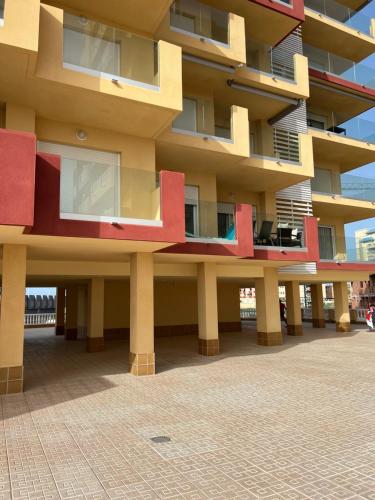 a large building with red and yellow at EMbers La Manga in San Blas