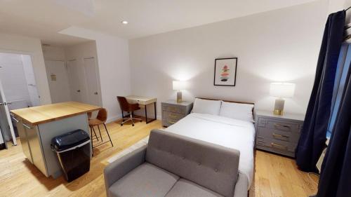 a bedroom with a bed and a desk and a chair at Apartment 1287: Chelsea in New York