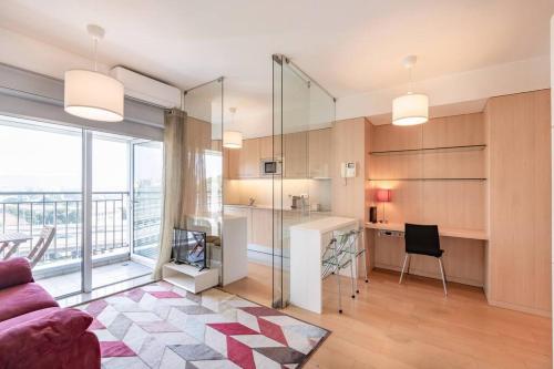 a living room with a couch and a table and a kitchen at VIVA Stadium Residence Studios in Porto