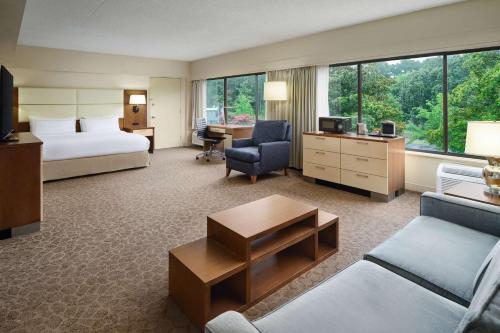 a hotel room with a bed and a living room at Doubletree by Hilton Hotel Williamsburg in Williamsburg
