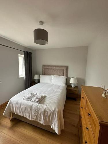 a bedroom with a bed and a dresser with two plates on it at Snug apartment centrally located in Galway