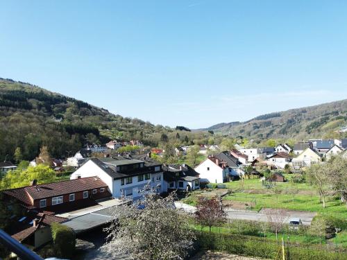 a small town with houses and mountains in the background at Nice studio near Luxembourg in Bollendorf