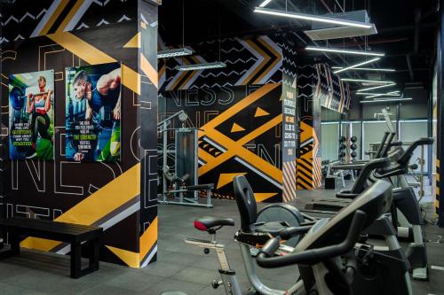 a gym with cardio machines and posters on the wall at Best Western Plus Metro Clark in Angeles