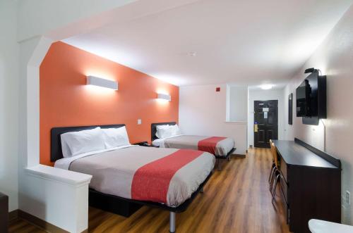 a hotel room with two beds and a television at Motel 6 Moss Point, MS in Moss Point