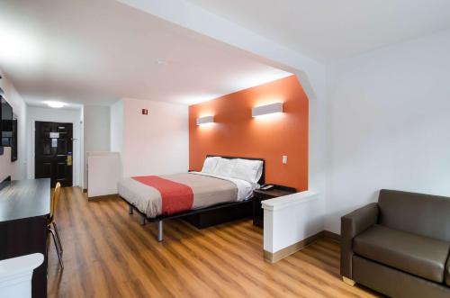 a small room with a bed and a couch at Motel 6 Moss Point, MS in Moss Point