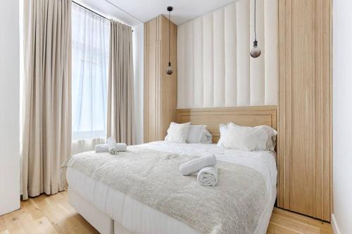 a bedroom with a large bed with two towels on it at Zen & Luxury 2BR Flat - Eiffel Tower in Paris