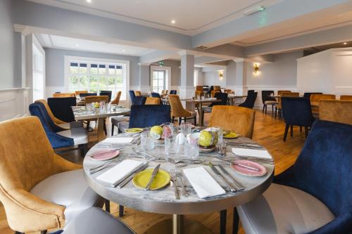 a dining room with a table and chairs at Gray's at Bushmills in Bushmills