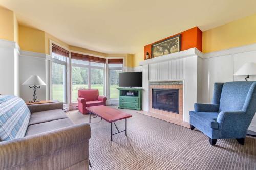 a living room with a couch and a fireplace at Hilton Grand Vacations Club Tremblant Canada in Mont-Tremblant