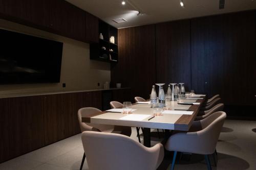 a dining room with a long table and chairs at Deep Blu Boutique Hotel in Żurrieq