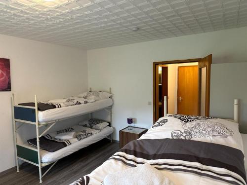 a bedroom with two bunk beds and a mirror at Gästehaus Rachinger in Pappenheim