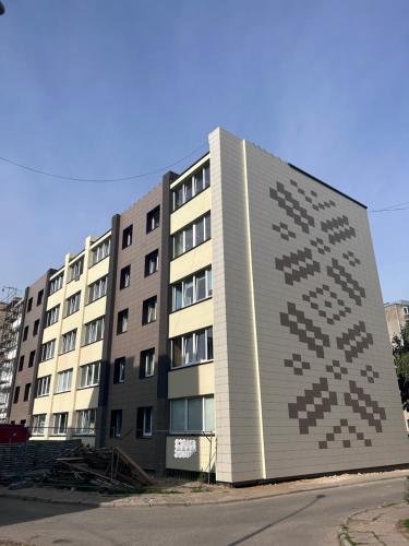 a large building with a large pixel pattern on it at Cozy Self Check-in CITY CENTRE apartment in Mažeikiai
