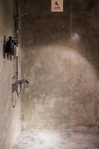 a shower in a room with a glass wall at Yu Apartment in Jiufen