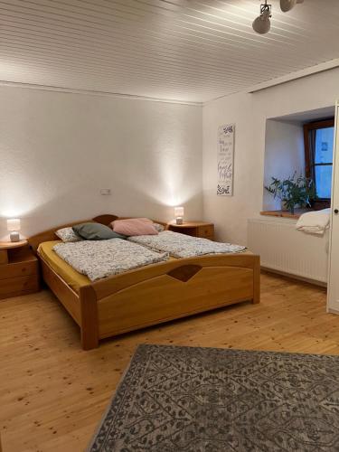a bedroom with a large wooden bed in a room at Ferienwohnung Mahar in Feistritz im Rosental