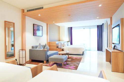 a hotel room with a bed and a living room at Da Nang - Mikazuki Japanese Resorts & Spa in Da Nang