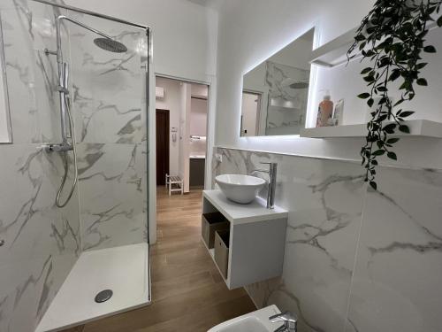 a white bathroom with a shower and a sink at Comfort Zone in Mestre