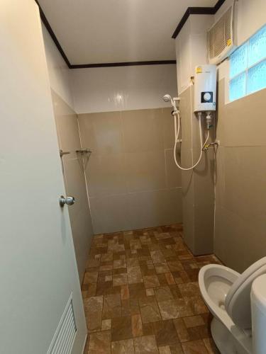 a small bathroom with a toilet and a shower at Lake View @Rakthai in Ban Thung Kha Han