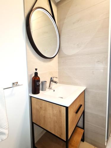 a bathroom with a sink and a mirror at My Sweet Homes - Le 15 in Colmar