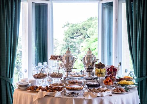 a table with food on it with a window at Hotel Franceschi in Forte dei Marmi