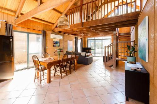 a kitchen and dining room with a table and chairs at Beachy Sleeps! Eco Friendly Family Retreat in Prevelly