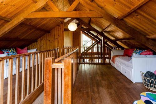 a large room with a wooden ceiling with wooden floors at Beachy Sleeps! Eco Friendly Family Retreat in Prevelly