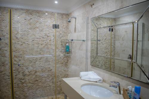 a bathroom with a shower and a sink and a mirror at Vista Views in Herolds Bay