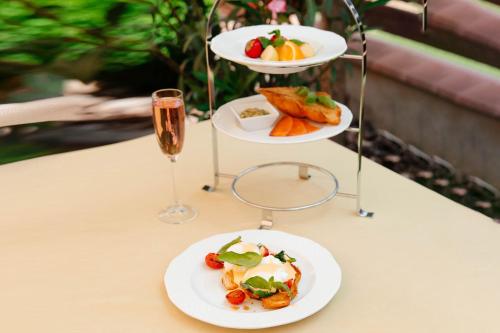 a table with two plates of food and a glass of champagne at Chizay. Мала Гора in Berehove