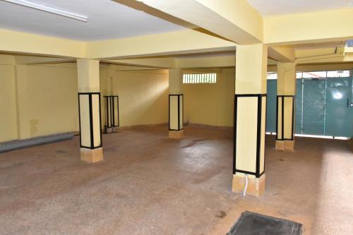 an empty room with pillars in the middle of a building at one bedroom in oj town ruiru in Kiambu