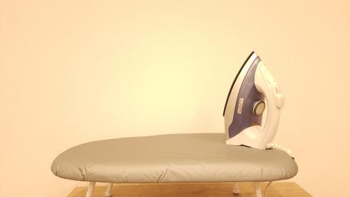 a chair with a monitor on top of it at Acro Capsule Hotel Namba Dotonbori in Osaka