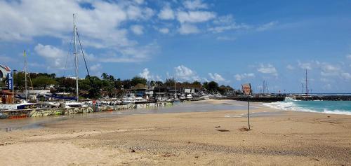 a beach with a marina with boats in the water at Ti jacques location - Saint-Gilles les bains - studio pour 2 personnes in Saint-Paul