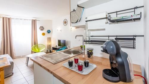 a kitchen with a mixer on top of a counter at Ti jacques location - Saint-Gilles les bains - studio pour 2 personnes in Saint-Paul