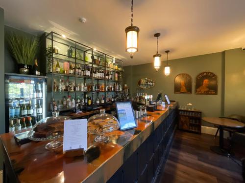 a bar in a restaurant with a lot of alcohol at The Riverside in Salisbury
