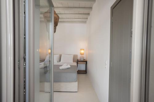 a small bedroom with a bed and a glass doorway at Private Villa Màou in Ano Mera