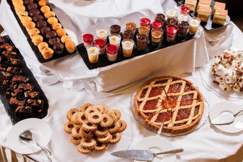 a table topped with different types of pastries and desserts at Hotel Slovenija - Terme & Wellness LifeClass in Portorož