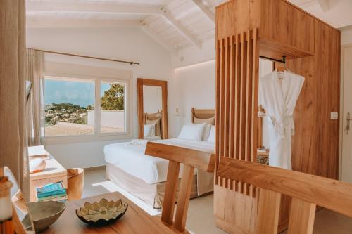 a bedroom with a bed and a window at Sivota's Secret Villa in Sivota